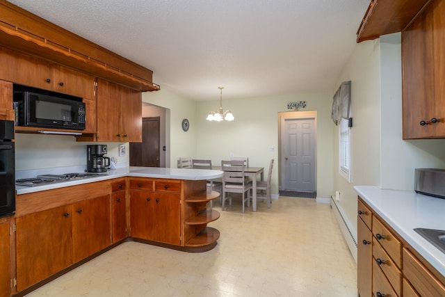 1001 Alexander St, Crookston, MN 56716 - kitchen featuring light countertops, a baseboard heating unit, a chandelier, and black appliances