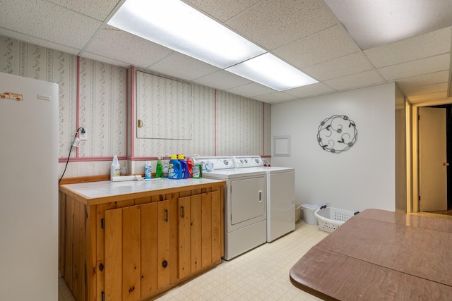 1001 Alexander St, Crookston, MN 56716 - laundry room featuring washer and clothes dryer, light floors, cabinet space, and wallpapered walls