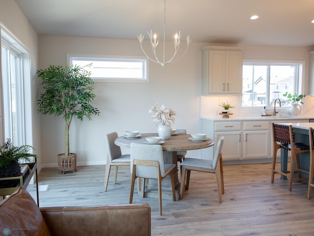 1490 66th Ave S, Fargo, ND 58104 - dining area featuring light wood-style floors, baseboards, an inviting chandelier, and recessed lighting