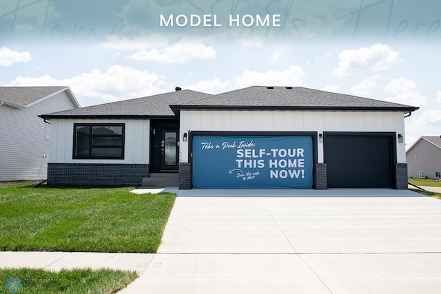 1490 66th Ave S, Fargo, ND 58104 - view of front of home featuring an attached garage, driveway, a front yard, brick siding, and a shingled roof