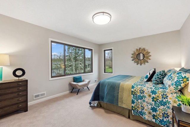 bedroom with light colored carpet, baseboards, and visible vents