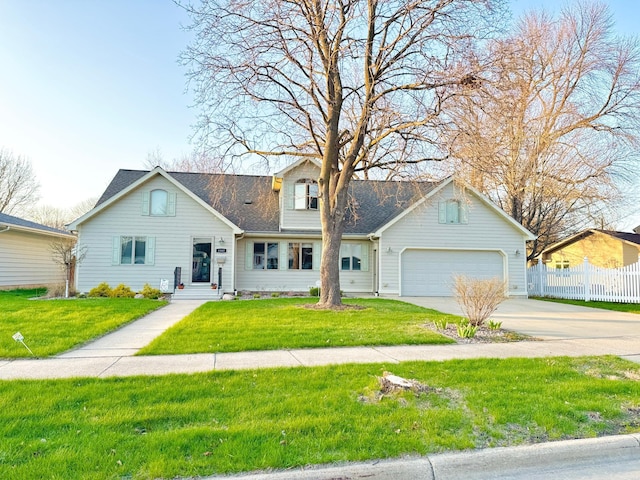 1502 4th Ave SW, Austin, MN 55912 - view of front facade featuring fence, a garage, roof with shingles, a front lawn, and concrete driveway