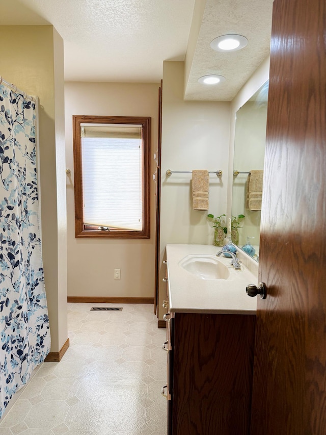 1502 4th Ave SW, Austin, MN 55912 - bathroom featuring a shower with curtain, visible vents, baseboards, recessed lighting, and vanity