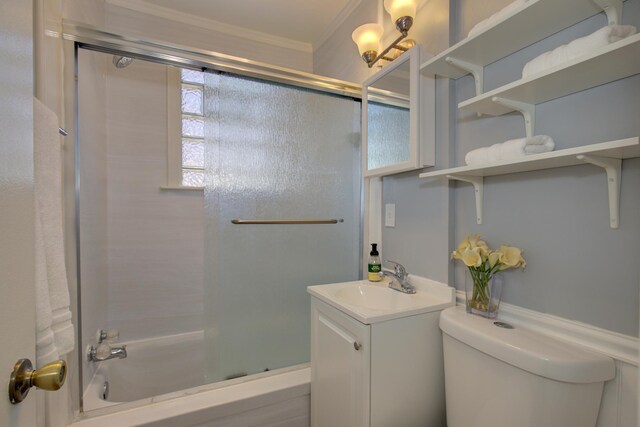 full bath with toilet, crown molding, bath / shower combo with glass door, and vanity