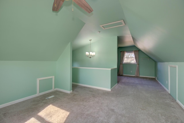 bonus room with lofted ceiling, ceiling fan with notable chandelier, carpet floors, and baseboards