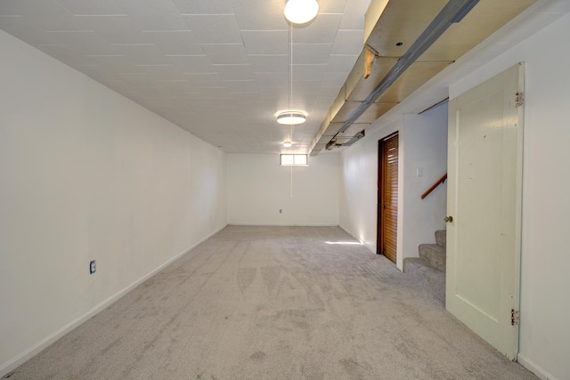 basement featuring stairway and carpet floors