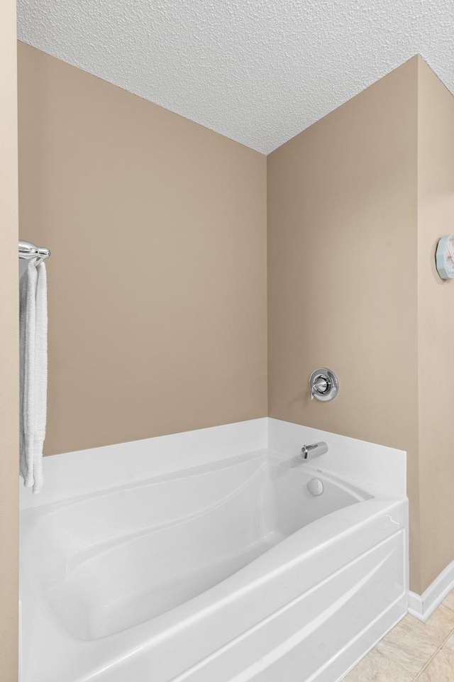 4584 Merganser Dr, Minnetrista, MN 55375 - full bathroom with a garden tub, tile patterned floors, a textured ceiling, and baseboards