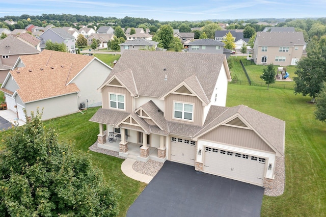 4584 Merganser Dr, Minnetrista, MN 55375 - view of front facade with covered porch, roof with shingles, stone siding, and aphalt driveway