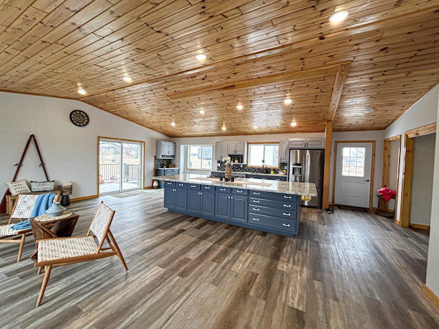 41634 Long Lake Rd, Ottertail, MN 56571 - kitchen with stainless steel fridge with ice dispenser, wood ceiling, blue cabinetry, a center island, and vaulted ceiling