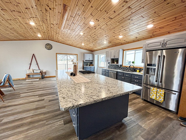 41634 Long Lake Rd, Ottertail, MN 56571 - kitchen with appliances with stainless steel finishes, a sink, dark wood-type flooring, vaulted ceiling, and a center island