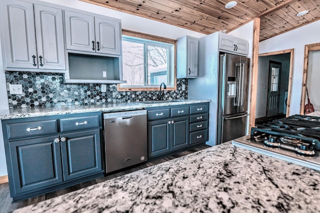 41634 Long Lake Rd, Ottertail, MN 56571 - kitchen with appliances with stainless steel finishes, a sink, wood ceiling, decorative backsplash, and light stone counters