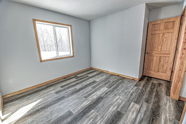 41634 Long Lake Rd, Ottertail, MN 56571 - spare room with wood finished floors, baseboards, and a textured ceiling