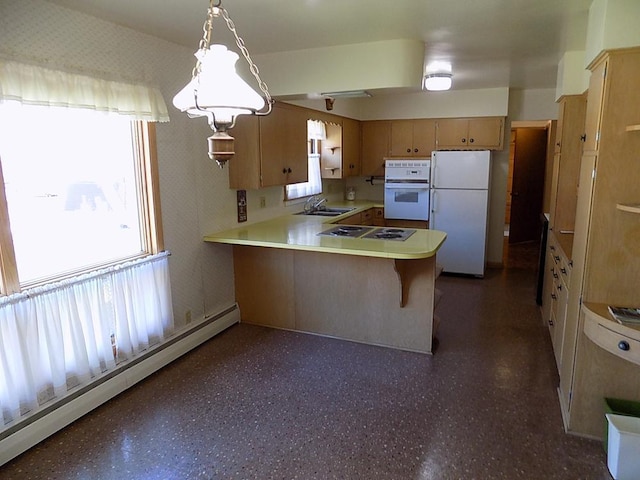 kitchen with a sink, a baseboard heating unit, white appliances, a wealth of natural light, and a peninsula