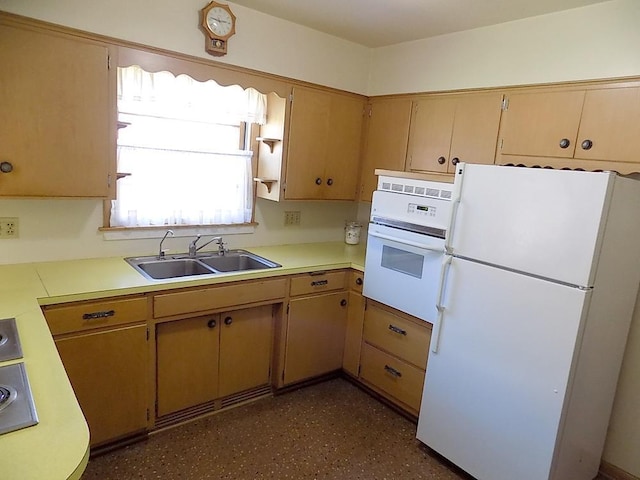 kitchen with light countertops, a sink, and white appliances