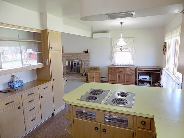 kitchen featuring light countertops, visible vents, an AC wall unit, a fireplace, and a baseboard radiator