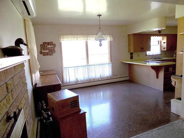 kitchen with baseboard heating, a sink, hanging light fixtures, a peninsula, and a wall unit AC