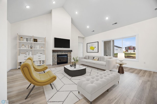 4242 Bristlecone Loop S, Fargo, ND 58104 - living room featuring light wood-style floors, high vaulted ceiling, a fireplace, and recessed lighting