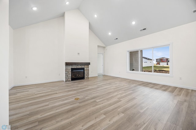 4242 Bristlecone Loop S, Fargo, ND 58104 - unfurnished living room with high vaulted ceiling, light wood-type flooring, recessed lighting, and a stone fireplace