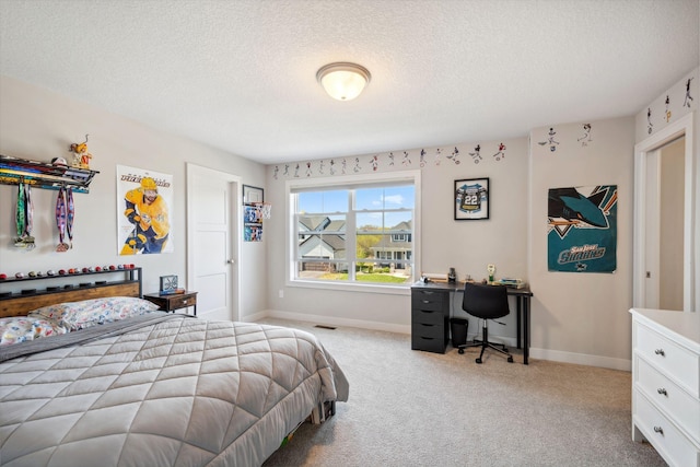 bedroom featuring carpet, a textured ceiling, visible vents, and baseboards