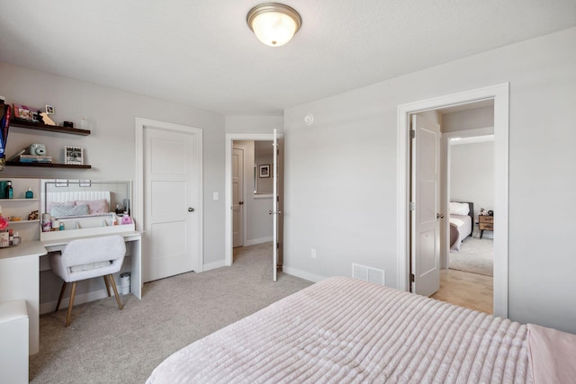 bedroom featuring carpet flooring, baseboards, and visible vents