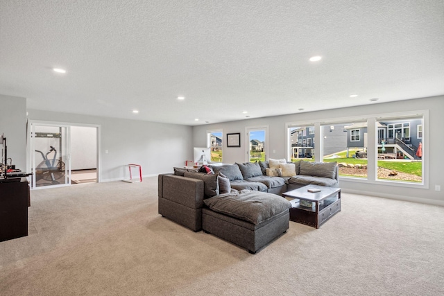 carpeted living area featuring baseboards, recessed lighting, and a textured ceiling