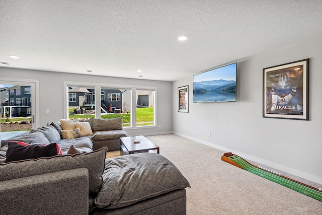 living room with a textured ceiling, carpet flooring, baseboards, and recessed lighting