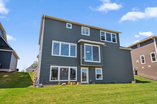 rear view of property with a yard