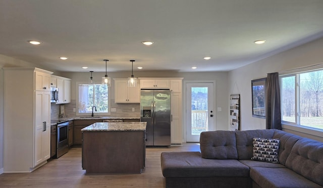1138 Pleasant Ct SW, Bemidji Twp, MN 56601 - kitchen featuring a sink, appliances with stainless steel finishes, plenty of natural light, and open floor plan