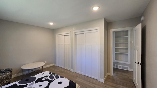 1138 Pleasant Ct SW, Bemidji Twp, MN 56601 - bedroom featuring multiple closets, recessed lighting, baseboards, wood finished floors, and visible vents