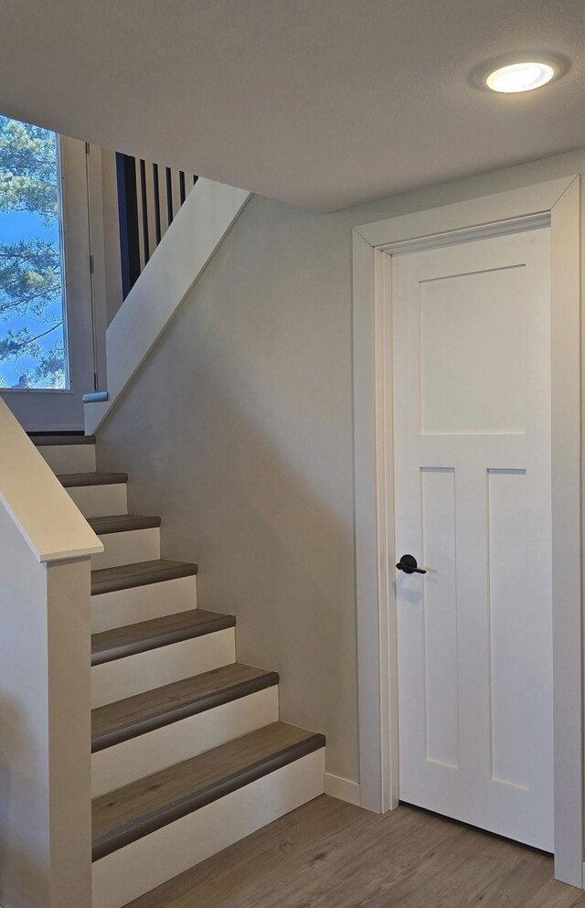 1138 Pleasant Ct SW, Bemidji Twp, MN 56601 - stairway featuring baseboards and wood finished floors