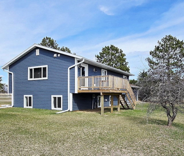 1138 Pleasant Ct SW, Bemidji Twp, MN 56601 - rear view of house featuring stairway, a deck, and a yard