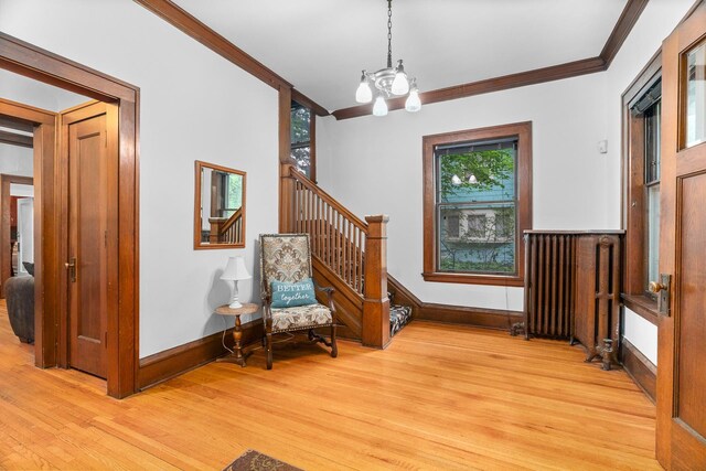 904 Lincoln Ave, Saint Paul, MN 55105 - sitting room featuring crown molding, light wood-style flooring, a chandelier, and stairway