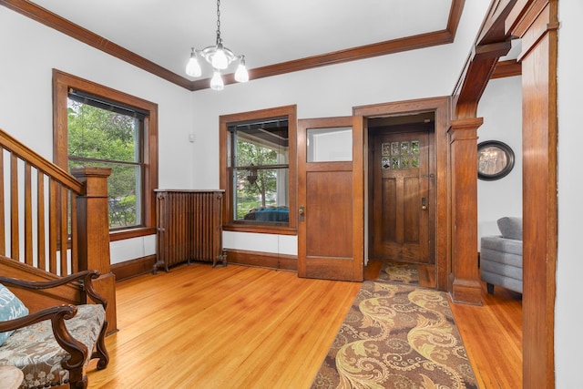 904 Lincoln Ave, Saint Paul, MN 55105 - entrance foyer featuring stairway, light wood-style flooring, crown molding, a chandelier, and healthy amount of natural light