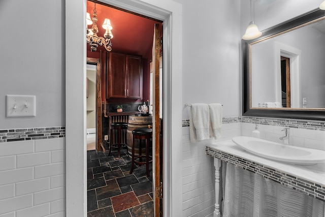904 Lincoln Ave, Saint Paul, MN 55105 - bathroom featuring tile walls, stone finish floors, and a wainscoted wall