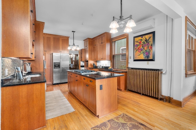 904 Lincoln Ave, Saint Paul, MN 55105 - kitchen featuring stainless steel appliances, radiator, a chandelier, a wall unit AC, and a center island