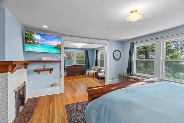 904 Lincoln Ave, Saint Paul, MN 55105 - bedroom with a brick fireplace and wood finished floors