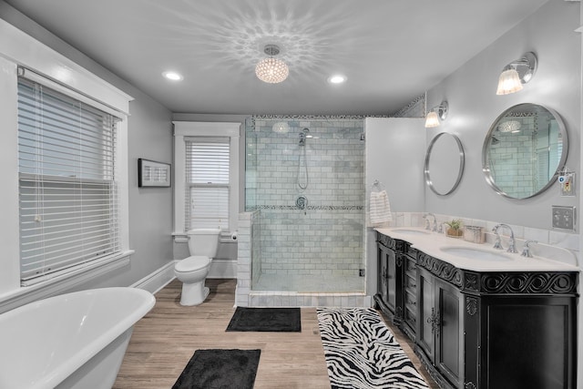 904 Lincoln Ave, Saint Paul, MN 55105 - bathroom with a stall shower, a freestanding bath, double vanity, recessed lighting, and wood finished floors