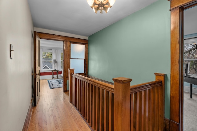904 Lincoln Ave, Saint Paul, MN 55105 - corridor with an upstairs landing, a chandelier, and light wood finished floors