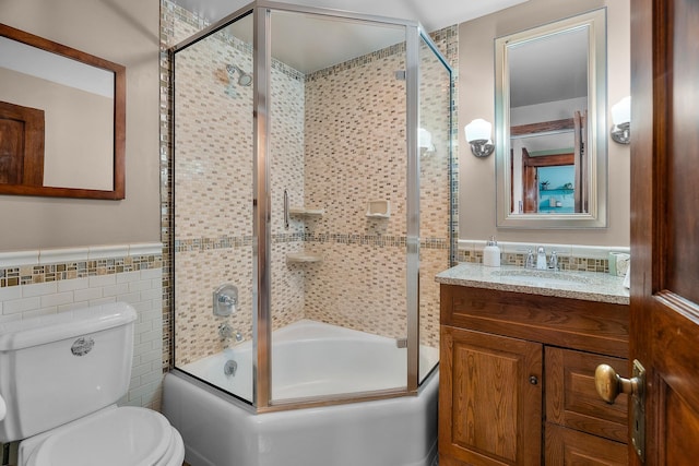 904 Lincoln Ave, Saint Paul, MN 55105 - full bathroom featuring tile walls, bath / shower combo with glass door, vanity, and a wainscoted wall