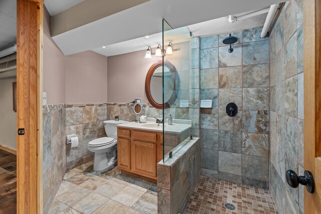 904 Lincoln Ave, Saint Paul, MN 55105 - full bathroom with tile walls, tiled shower, vanity, and wainscoting