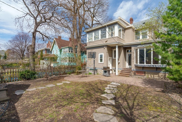 904 Lincoln Ave, Saint Paul, MN 55105 - rear view of house with a chimney and a patio area
