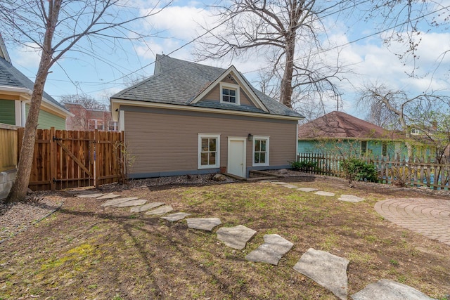 904 Lincoln Ave, Saint Paul, MN 55105 - rear view of property featuring a fenced backyard, a shingled roof, and a gate