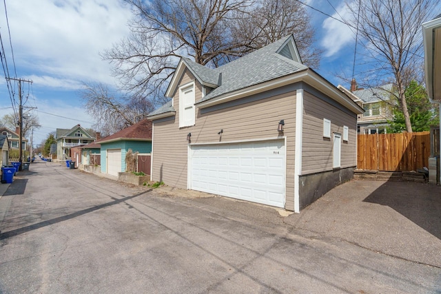 904 Lincoln Ave, Saint Paul, MN 55105 - view of home's exterior featuring roof with shingles, a garage, and driveway