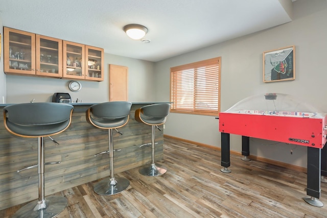 bar with baseboards and wood finished floors