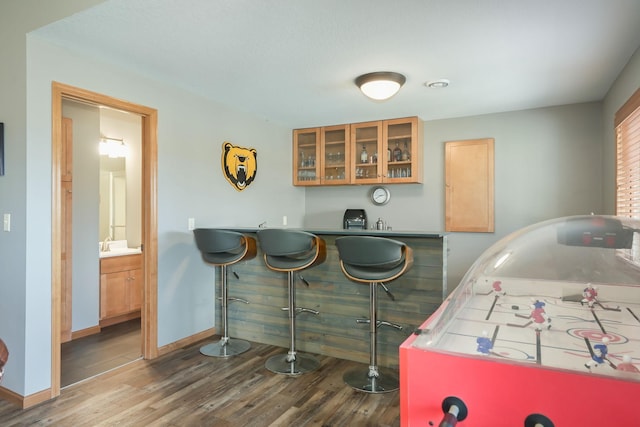 playroom with baseboards and wood finished floors