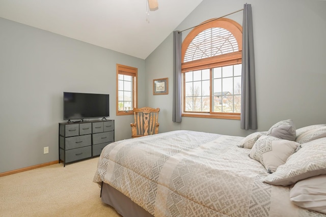 carpeted bedroom featuring baseboards, ceiling fan, and high vaulted ceiling