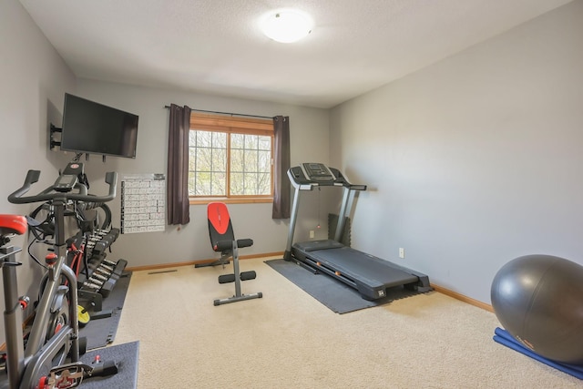 workout room featuring carpet flooring and baseboards