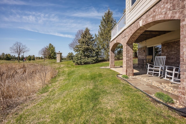 view of yard with a patio area and a balcony