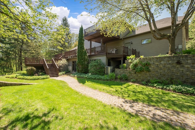 rear view of property featuring stairway, a lawn, a balcony, and a wooden deck