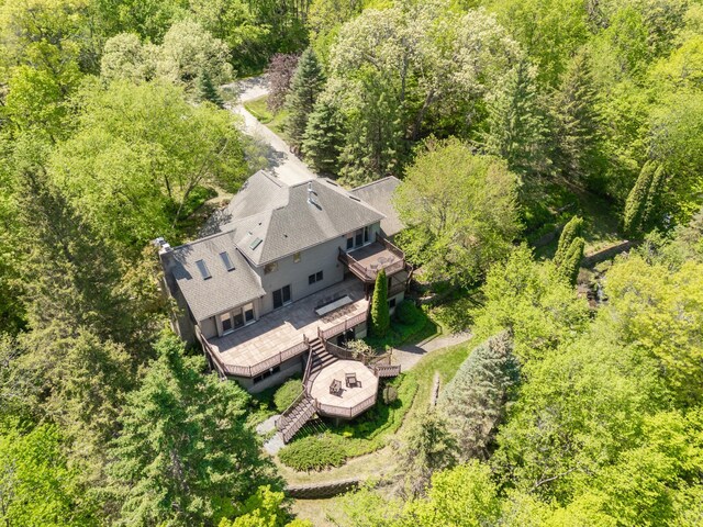 aerial view of property and surrounding area featuring a forest